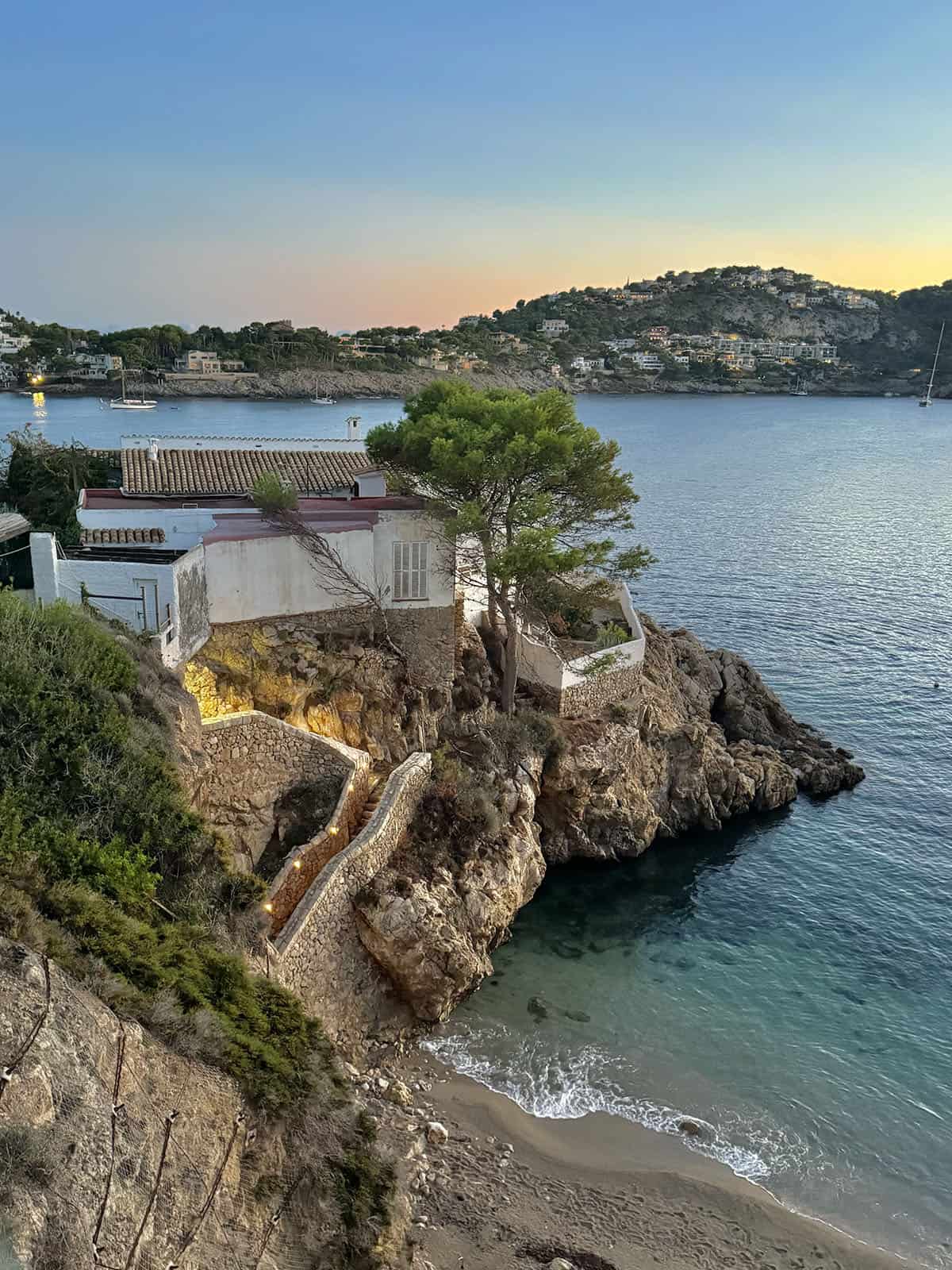 An image of the cliffside and beach at Port D'Andratx during a beautiful sunset 