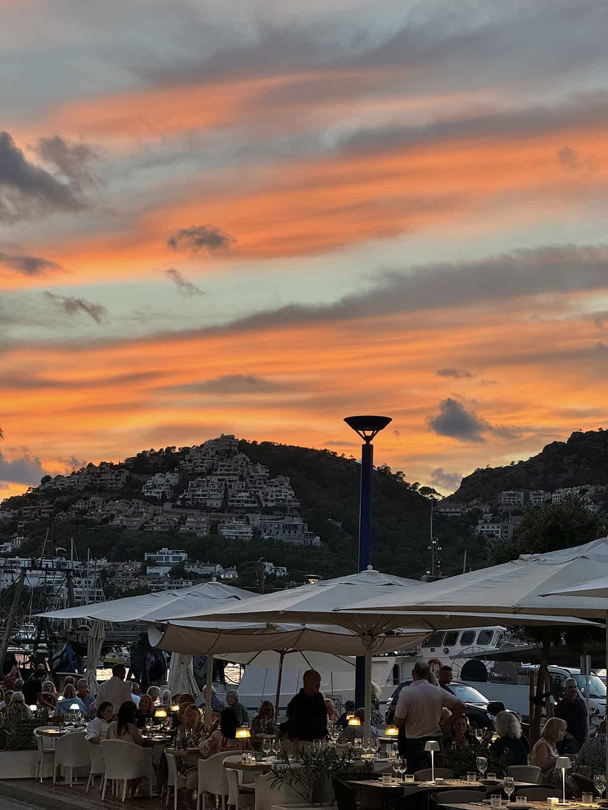 An image of restaurants at Port D'Andratx with a beautiful sunset in the background