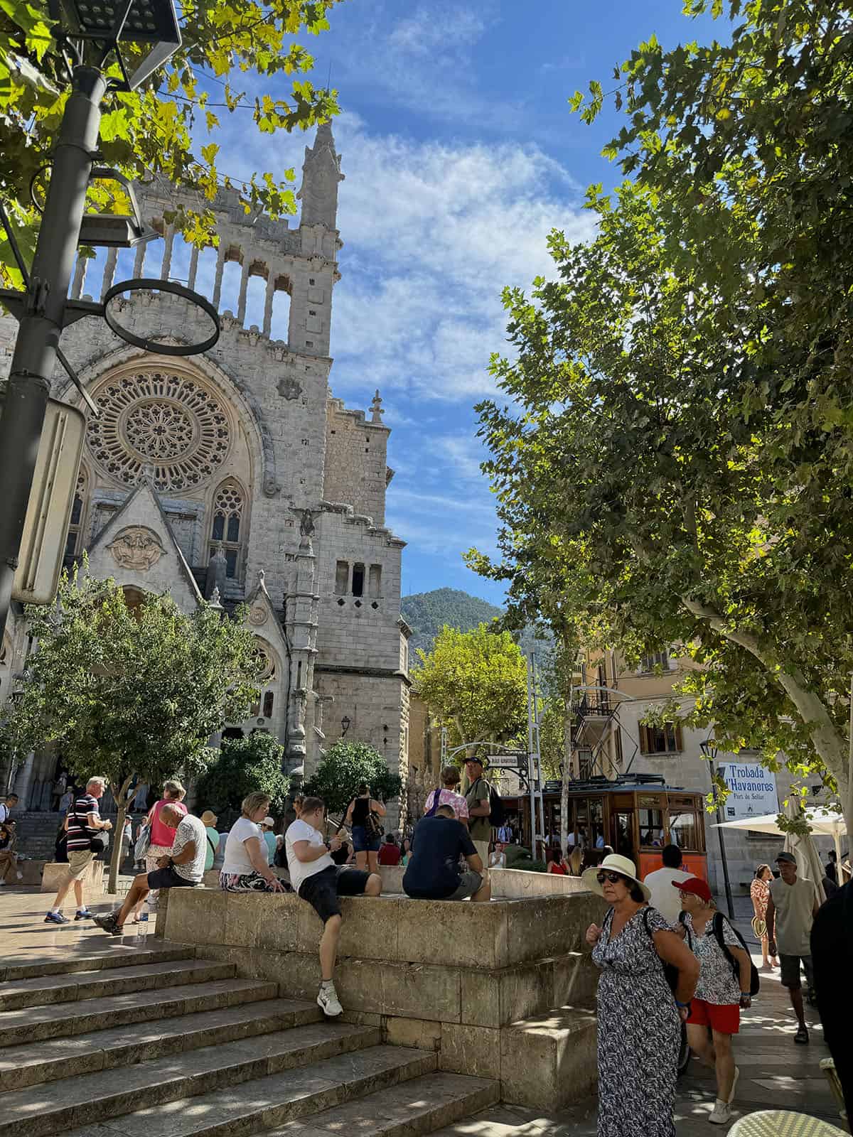 An image of the main square in Soller with a red tram in the background