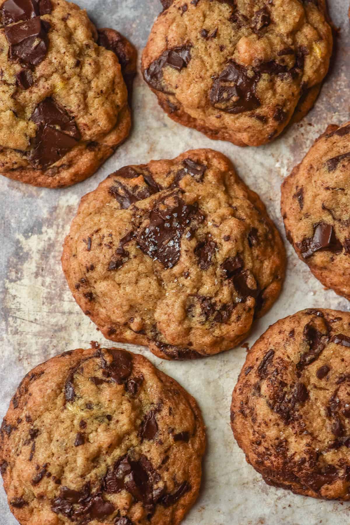 An aerial image of gluten free egg free banana choc chip cookies on a baking tray lined with white baking paper