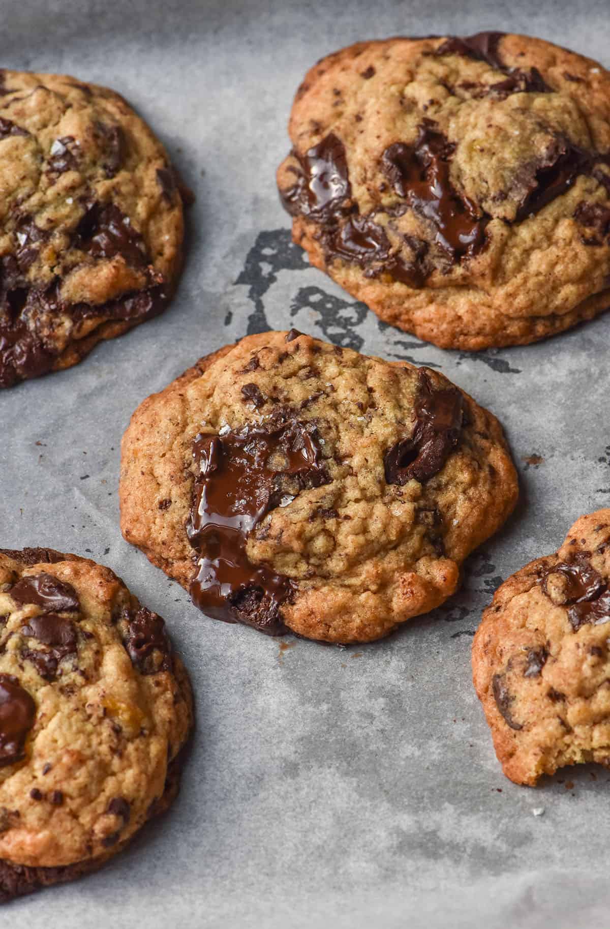 An aerial image of gluten free egg free banana choc chip cookies on a baking tray lined with white baking paper