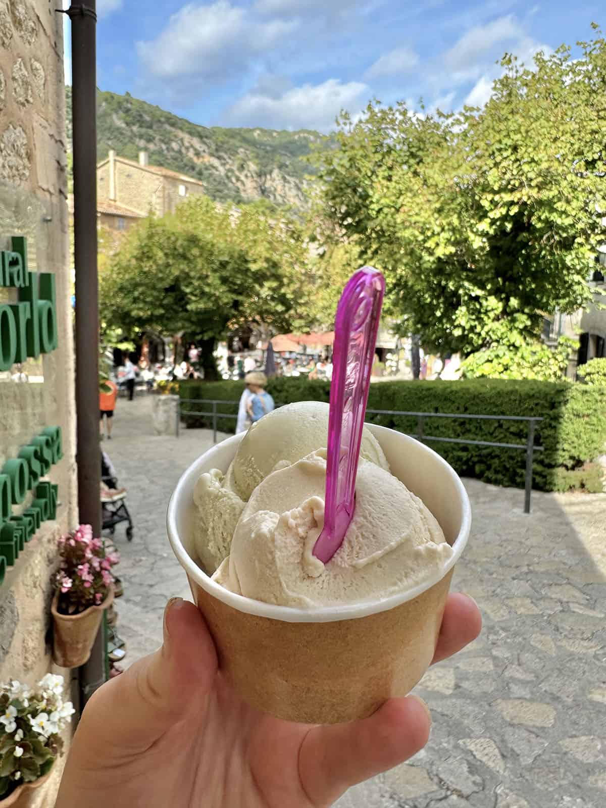 An image of an ice cream set against the town square of Vallemossa