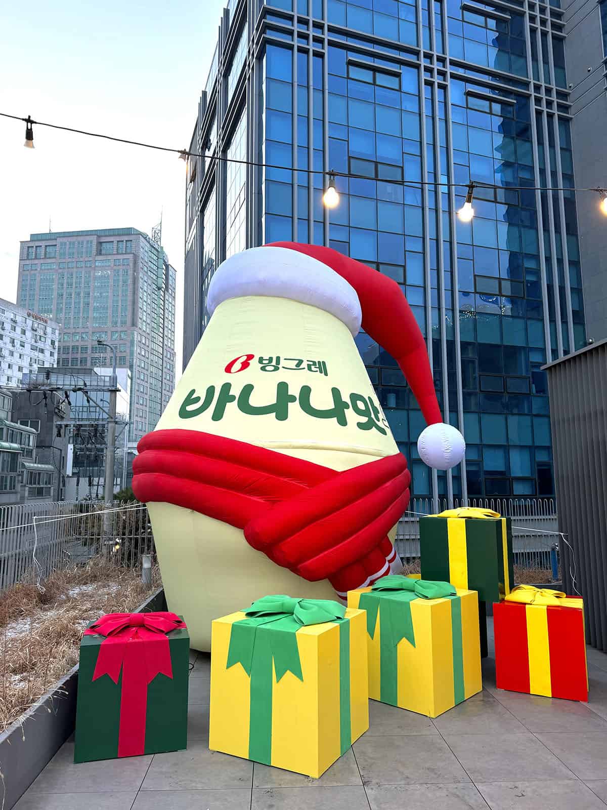 An image of a giant Korean banana milk with a Santa hat on at a popup in Insadong, Seoul