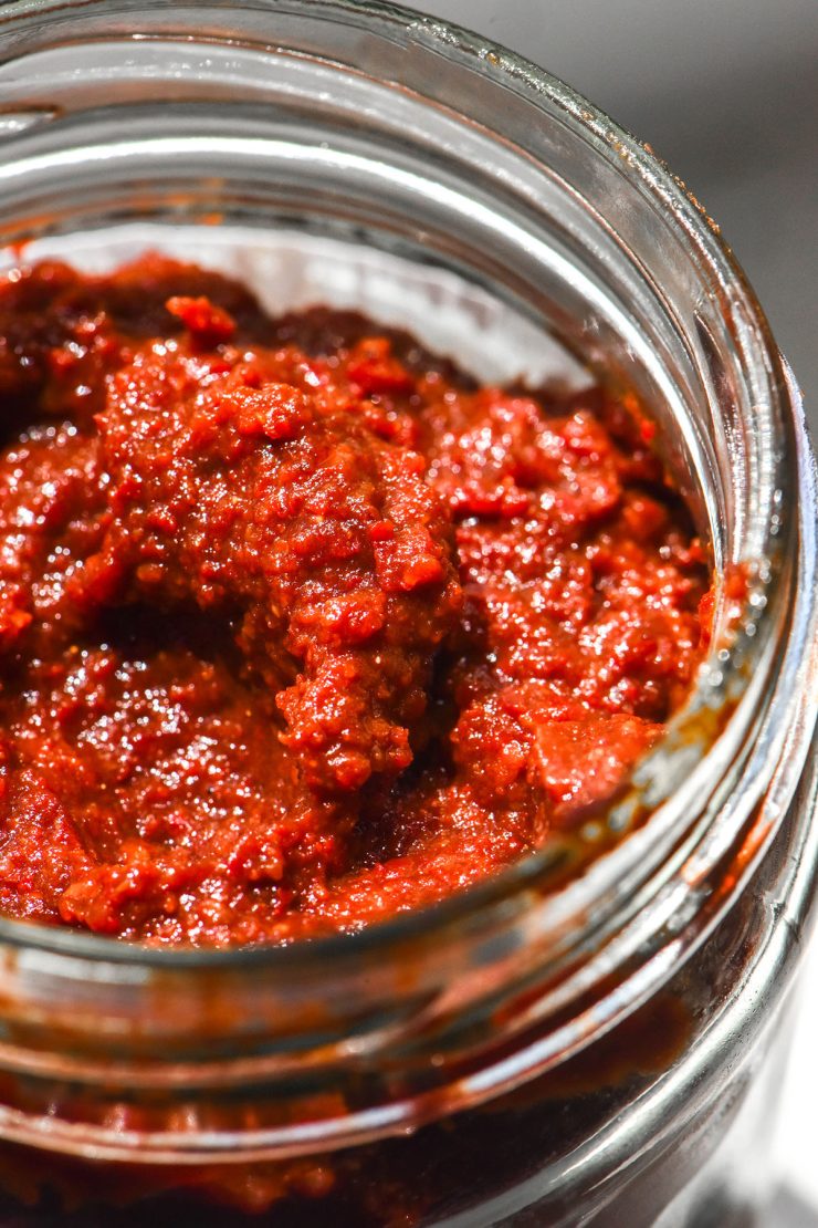 A close up macro image of a jar of gluten free gochujang