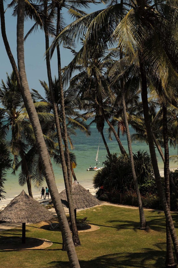 A photo of a sunny palm treed beach in Mombasa, Kenya as seen from Sarova Whitesands hotel