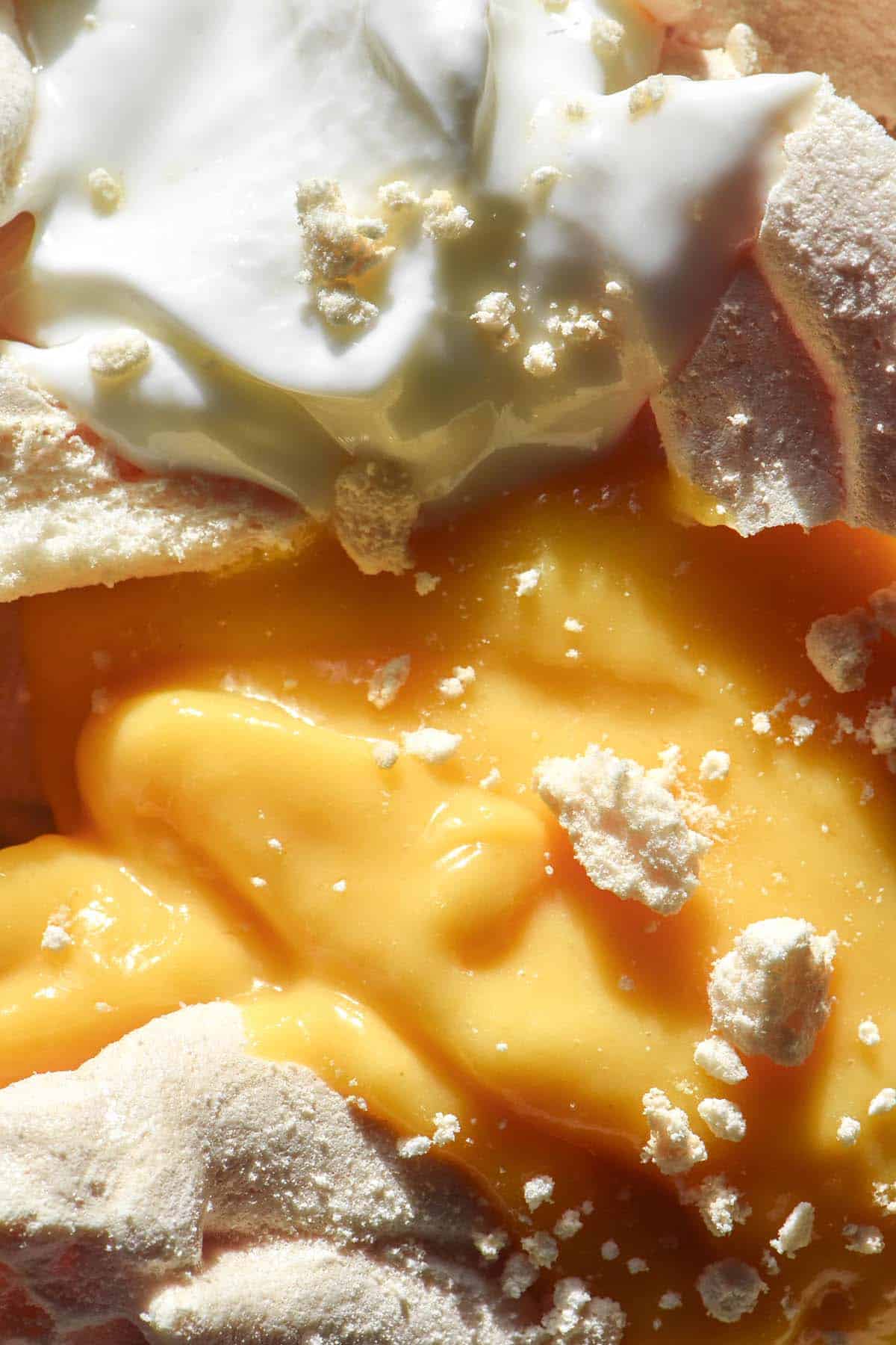 A macro aerial image of an Eton mess with mango curd