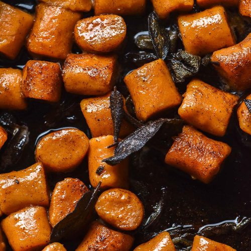 An aerial image of gluten free sweet potato gnocchi in brown sage butter in a cast iron skillet