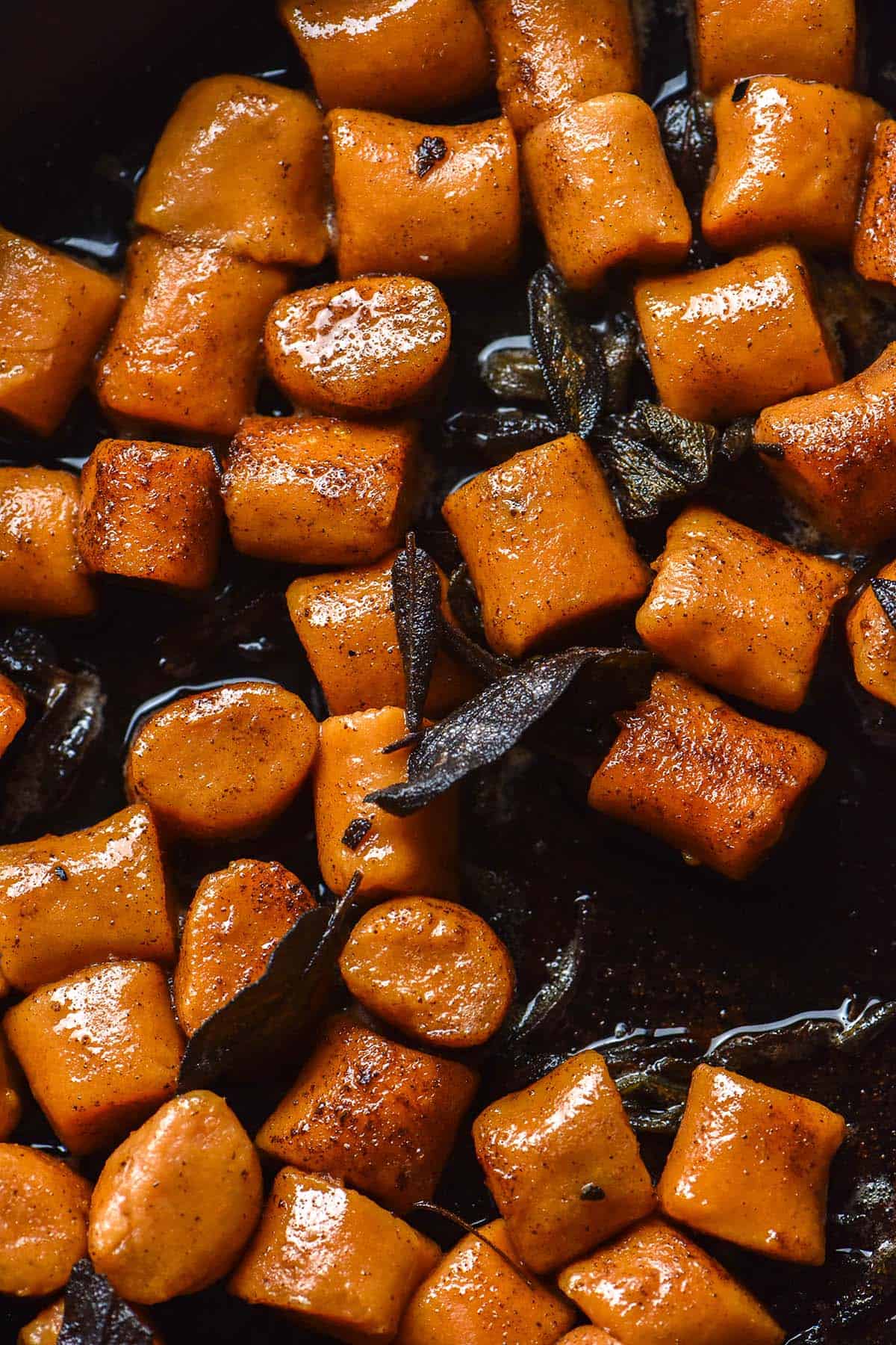 An aerial image of gluten free sweet potato in brown butter sage sauce in a cast iron skillet