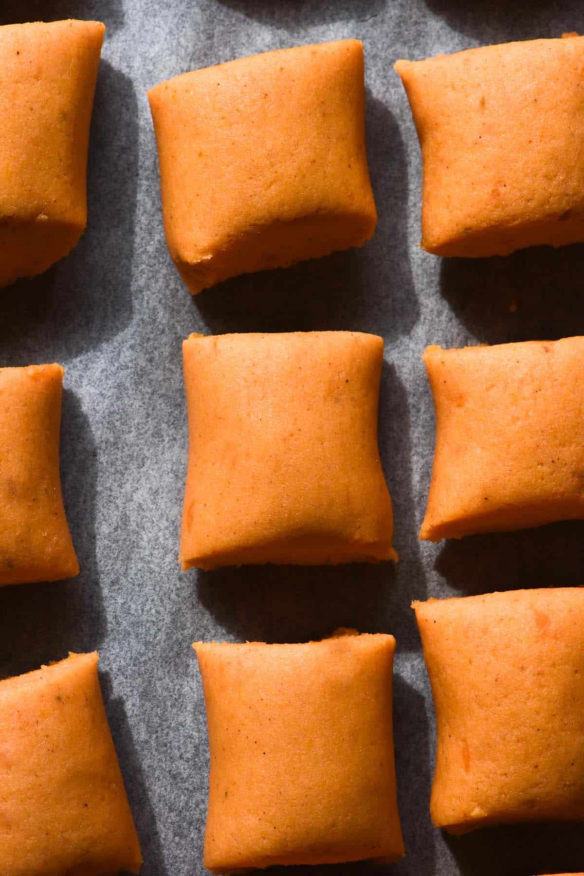 An aerial image of gluten free sweet potato gnocchi on a baking tray after being shaped