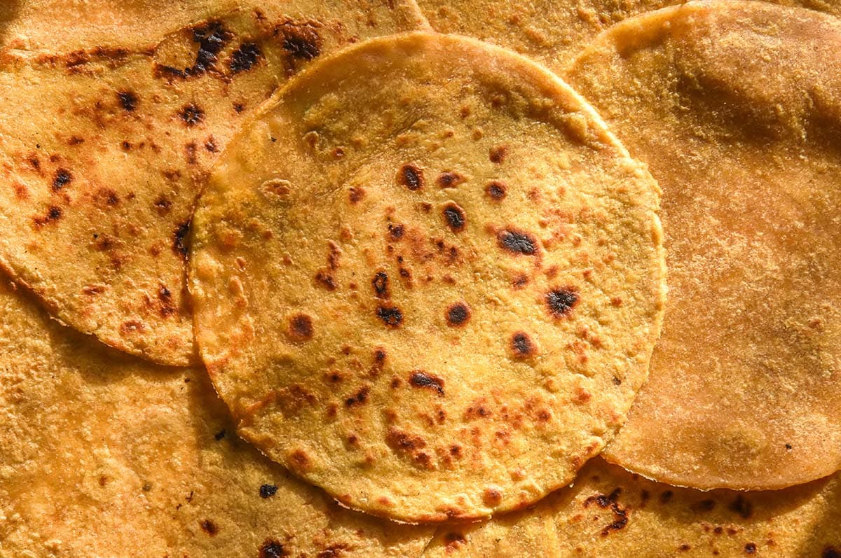 An aerial macro image of sweet potato tortillas casually arranged on a surface