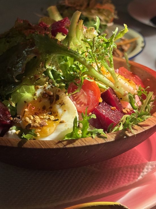 A moodily lit image of a salad bowl at Beit e Selam in Nairobi, Kenya