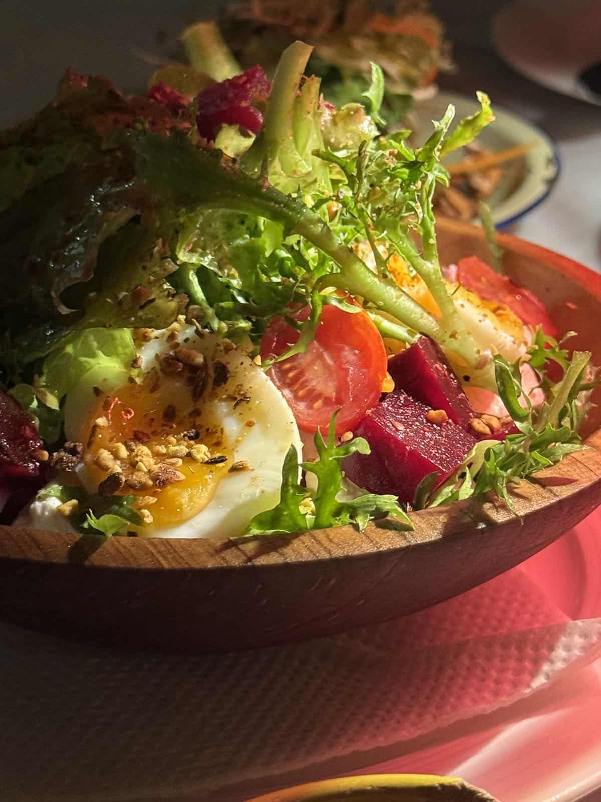 A moodily lit image of a salad bowl at Beit e Selam in Nairobi, Kenya