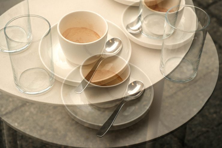 A double exposure image of coffee cups and water glasses on a table at Suuapinga in Munich, Germany