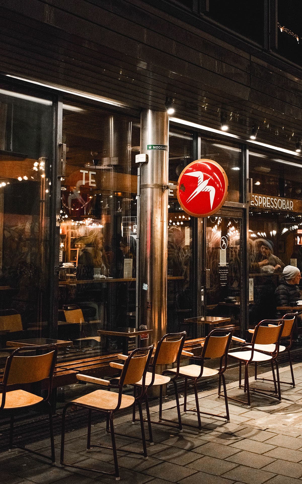 An image of the exterior of Fuglen Coffee shop in Oslo at night