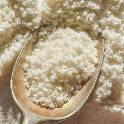 An aerial image of gluten free panko crumbs on a plate and spoon