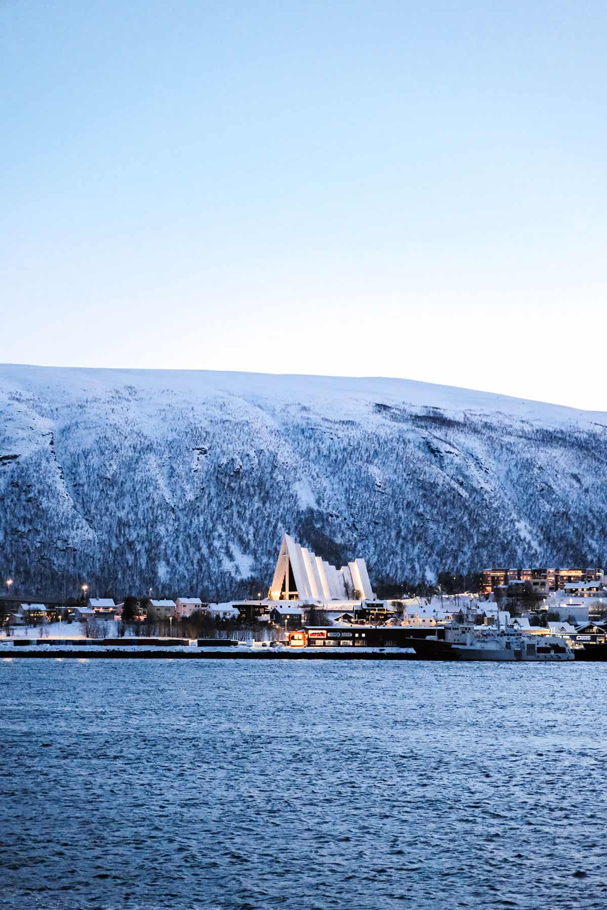 An image of the Arctic Cathedral in Tromso, Norway on a cold winter morning as seen from the other side of the water
