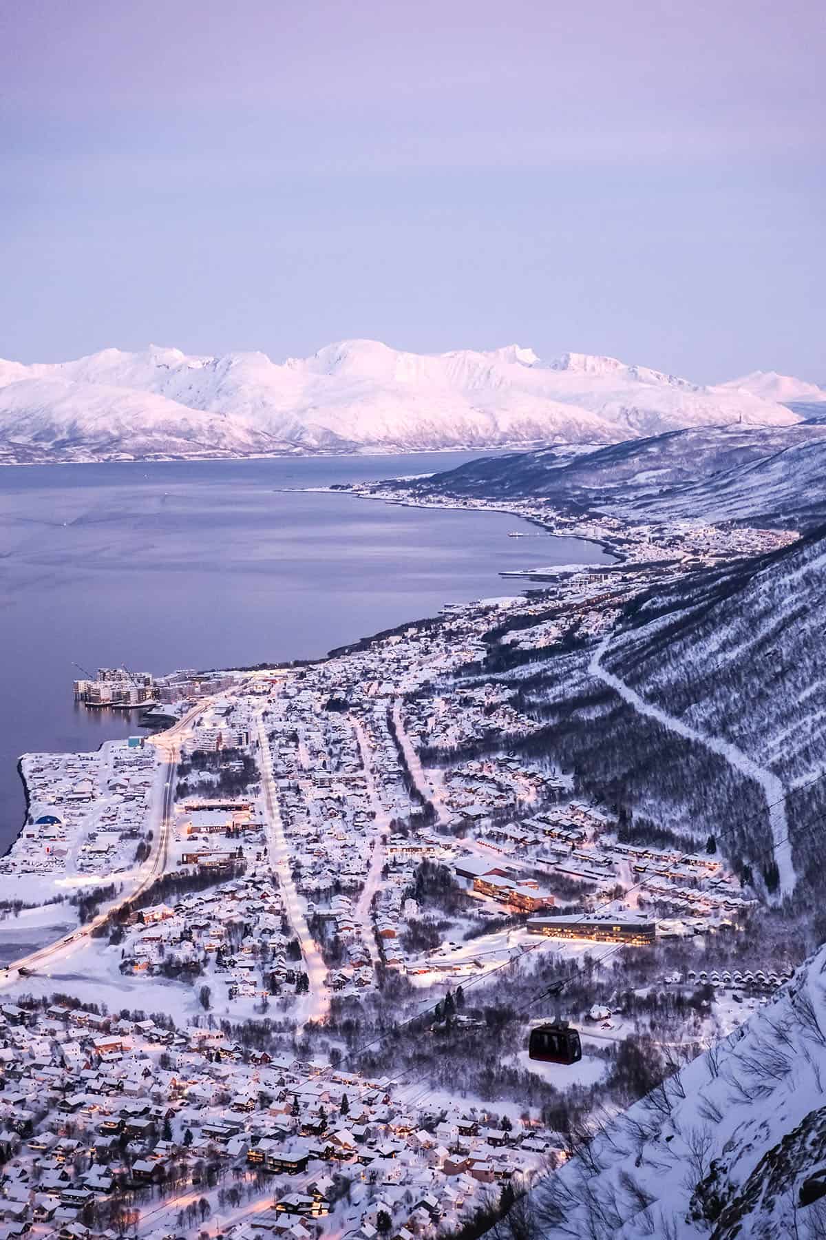 An image of Fjellheisen during winter in Tromso, Norway with a pink hued sky