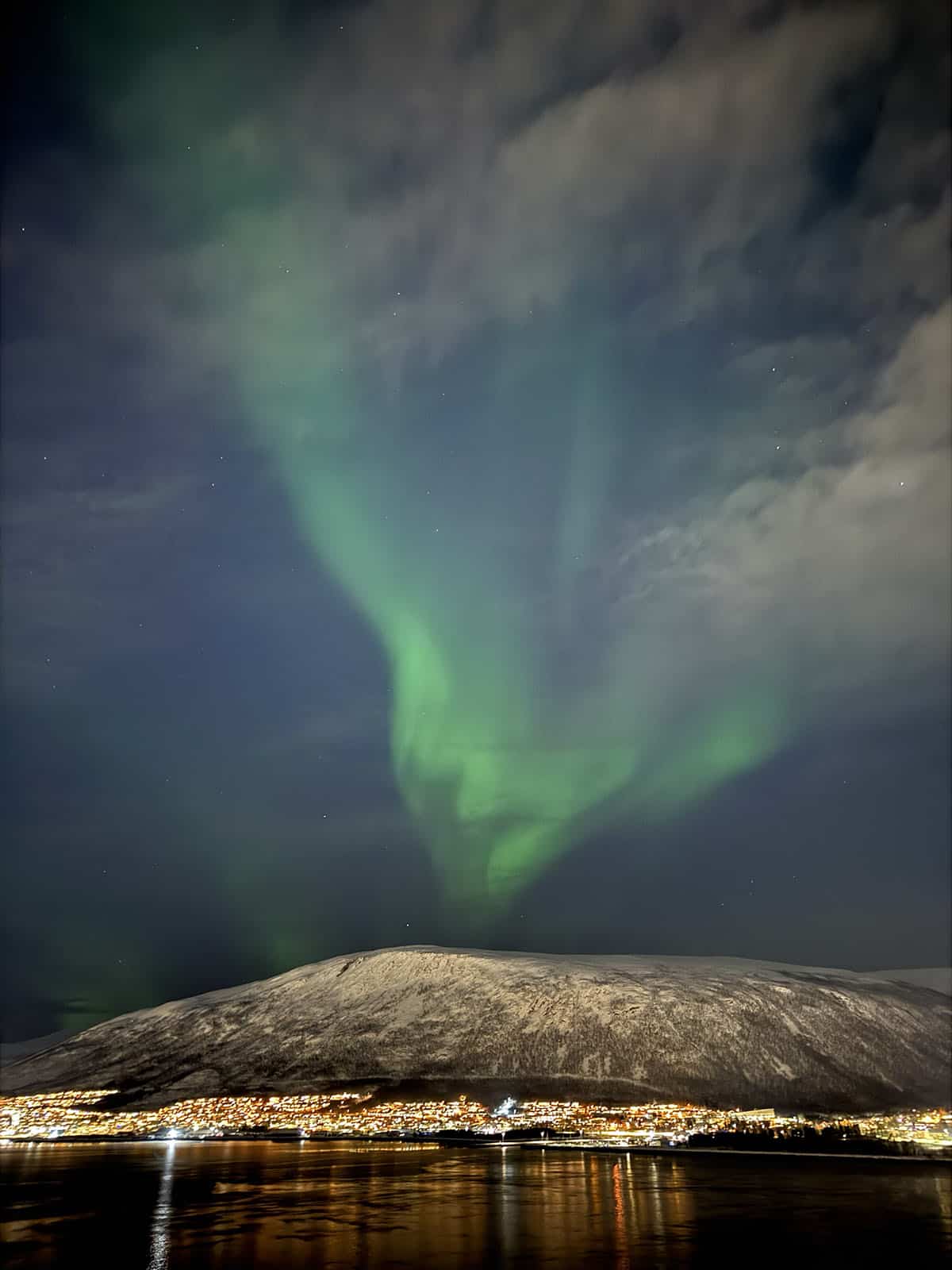 A view of the Northern Lights in Tromso on a cloudy evening