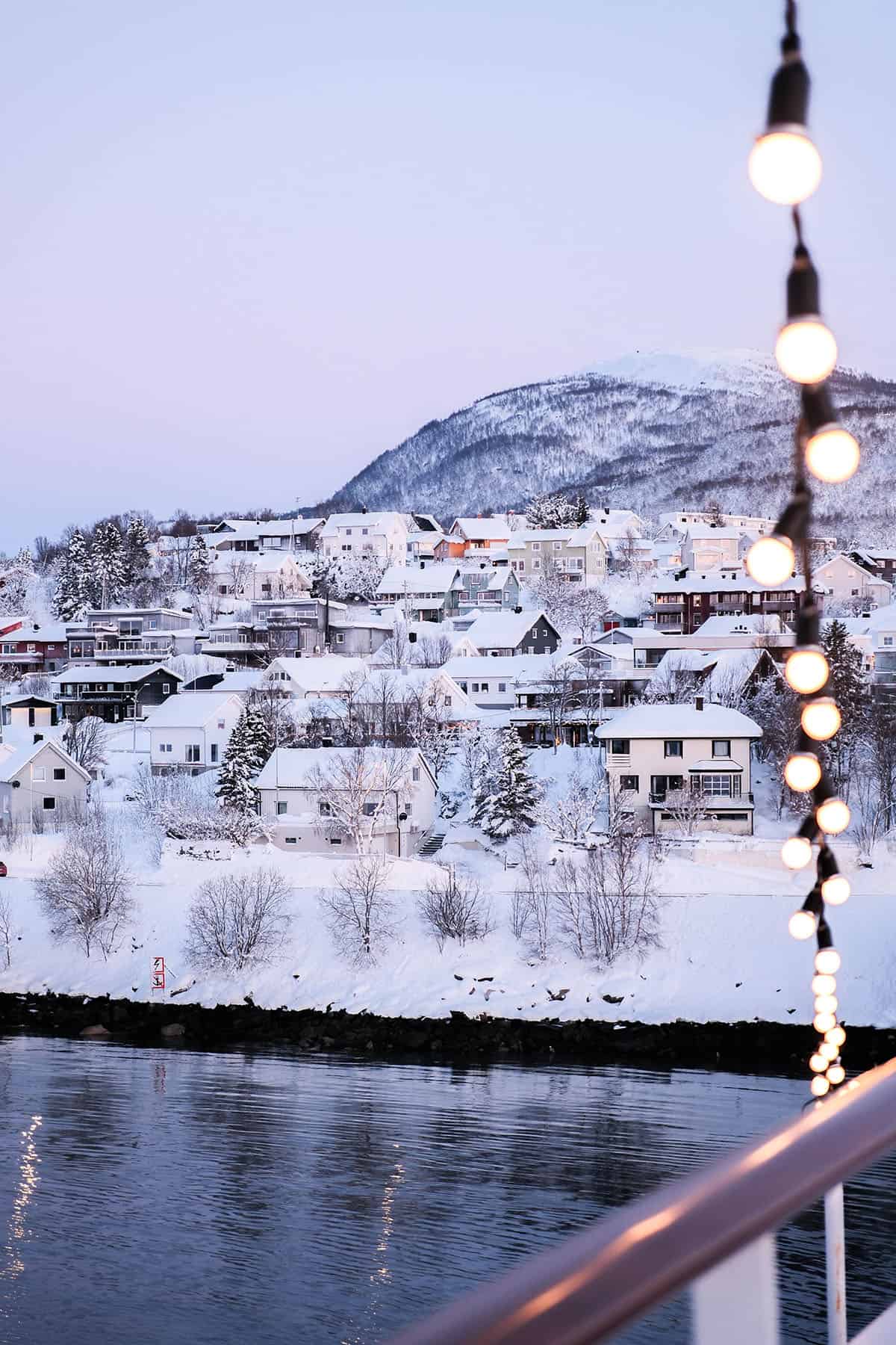 An image of a snow covered village in Norway as seen from the Havila Polaris