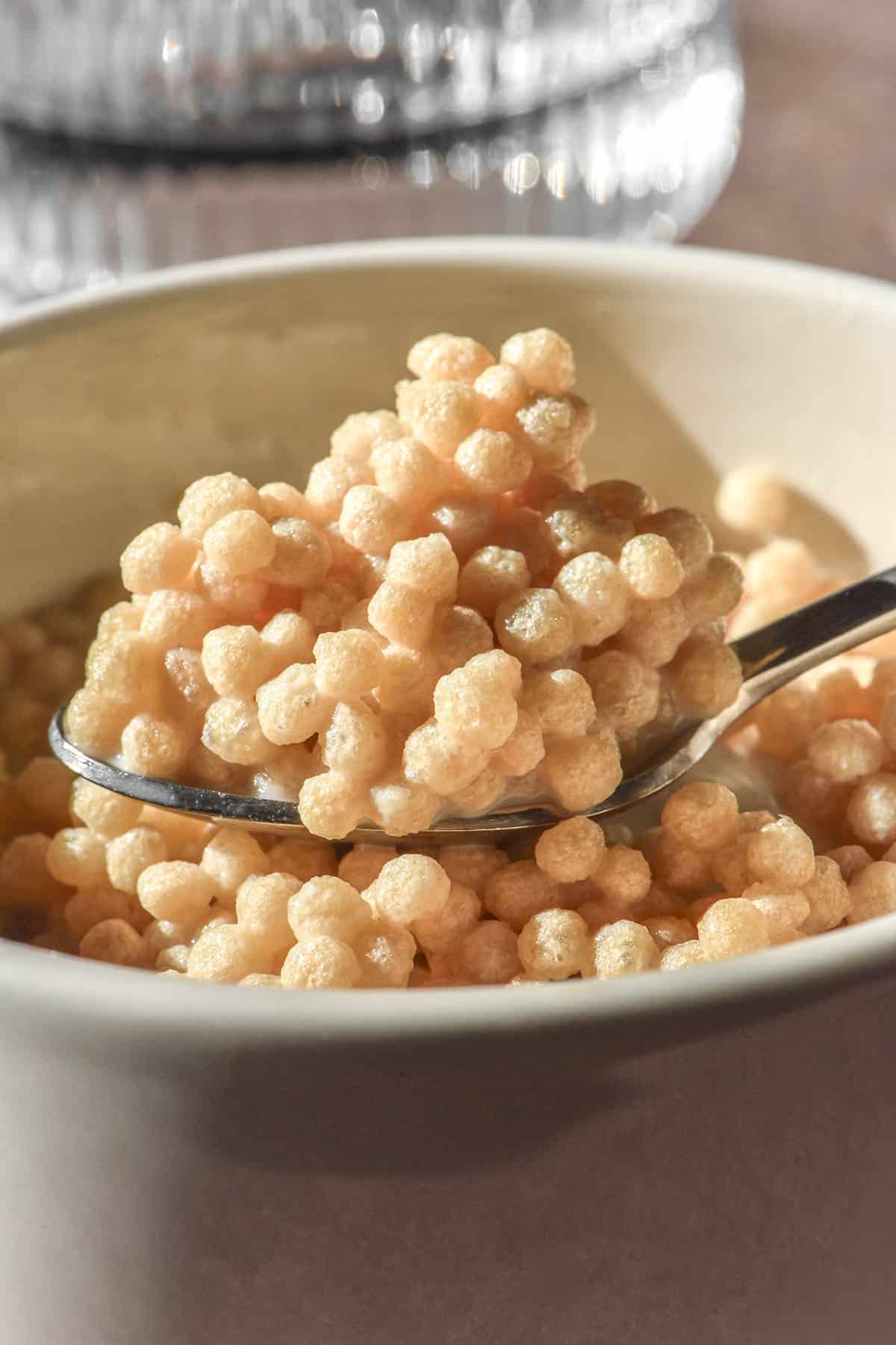A close up side on view of protein crisp cereal in a white ceramic bowl