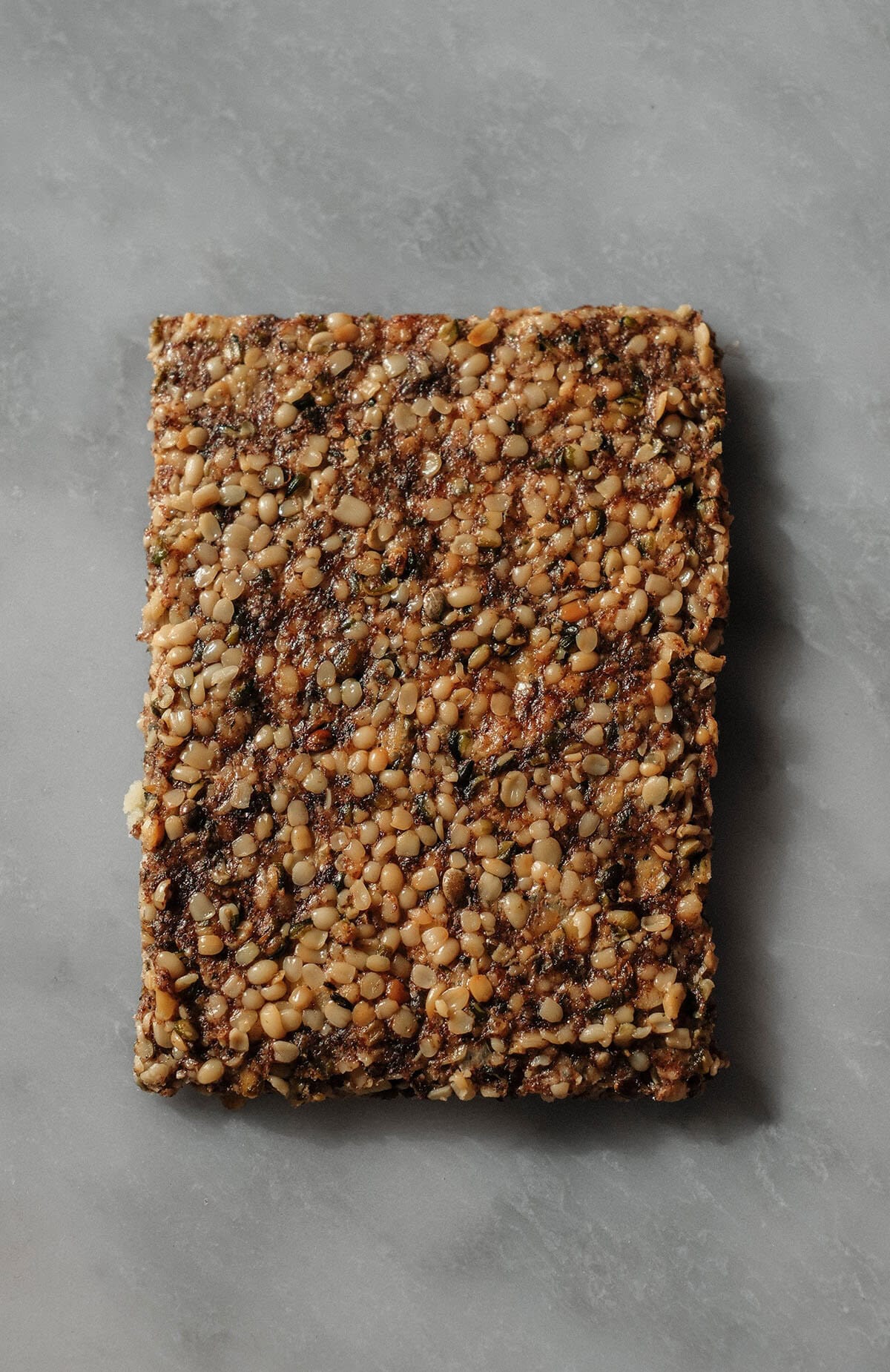 An aerial image of a high protein cracker atop a white marble table